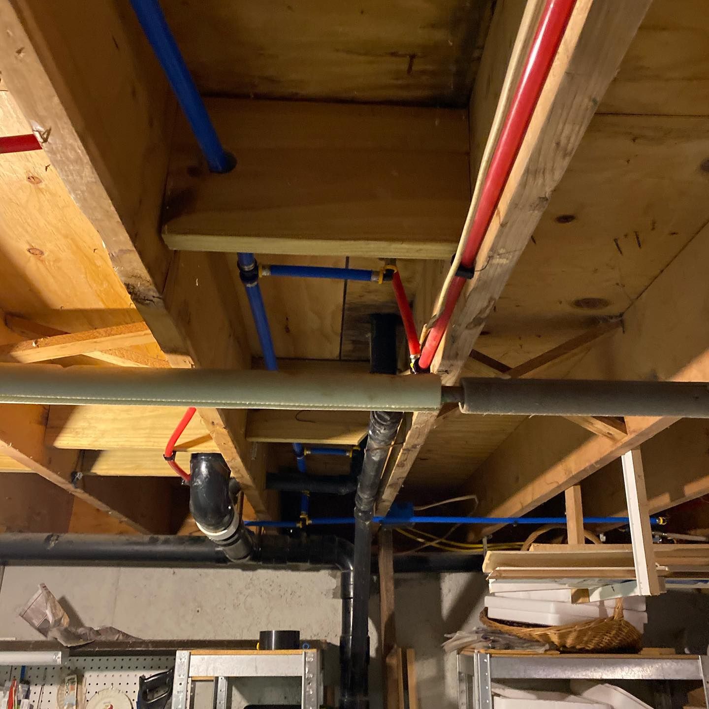 A bunch of pipes are hanging from the ceiling of a building