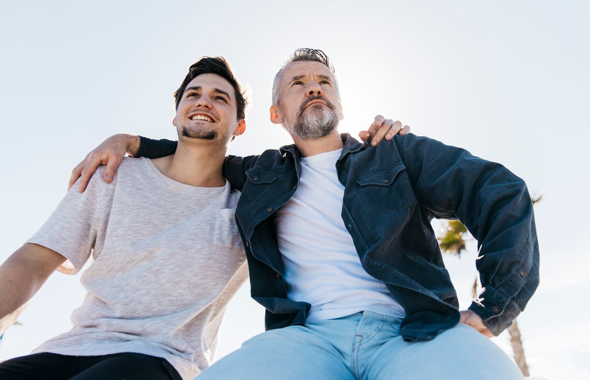 A family is sitting next to a dog wearing a cowboy hat.