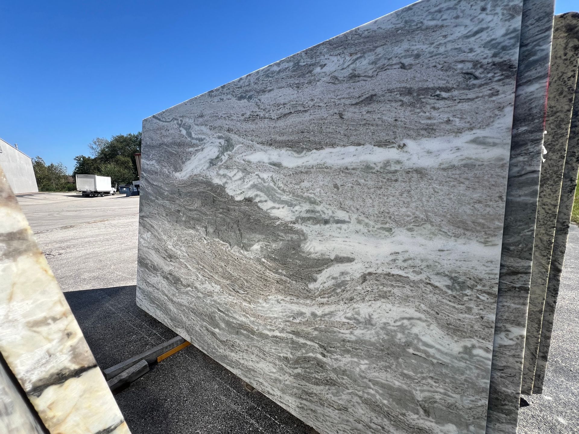 A large black granite slab is sitting on top of a concrete surface.