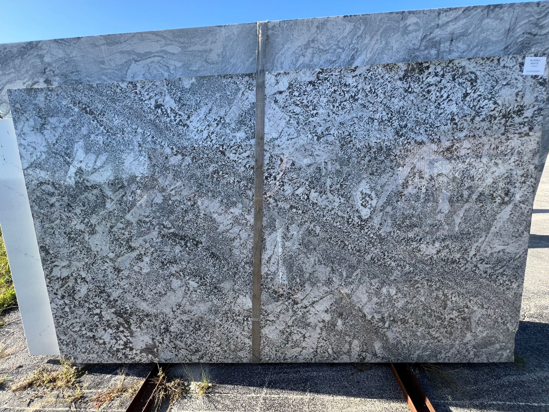 A large piece of granite is sitting on top of a concrete surface.