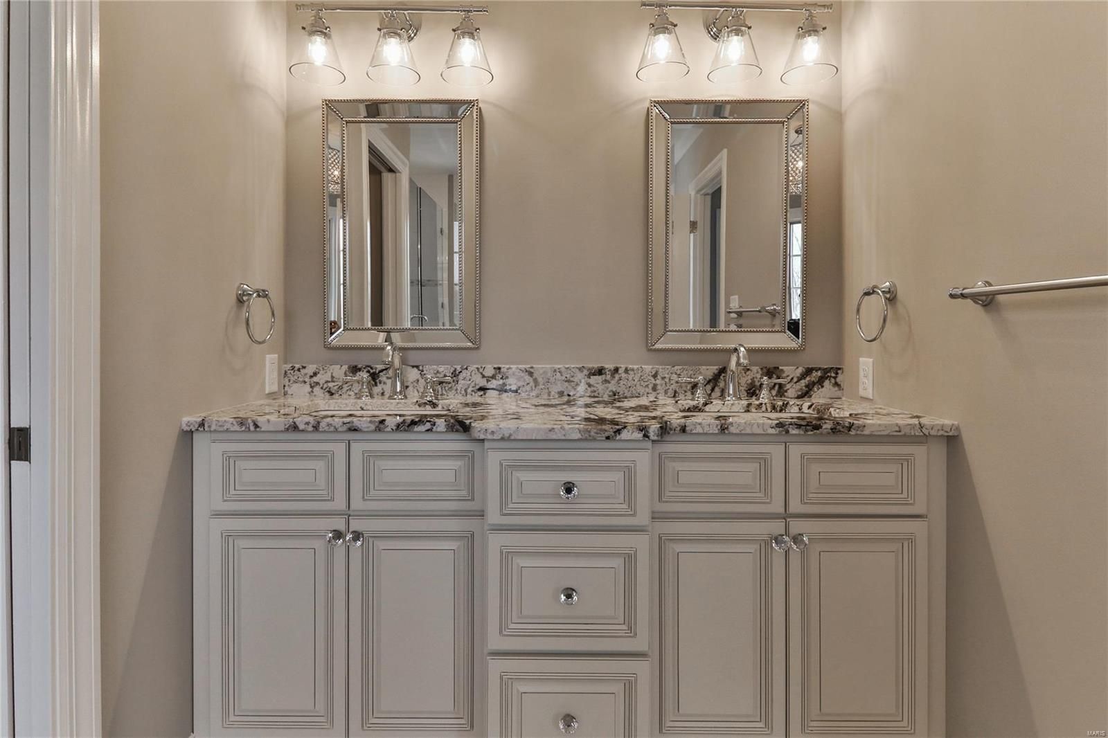 A bathroom with two sinks and two mirrors.