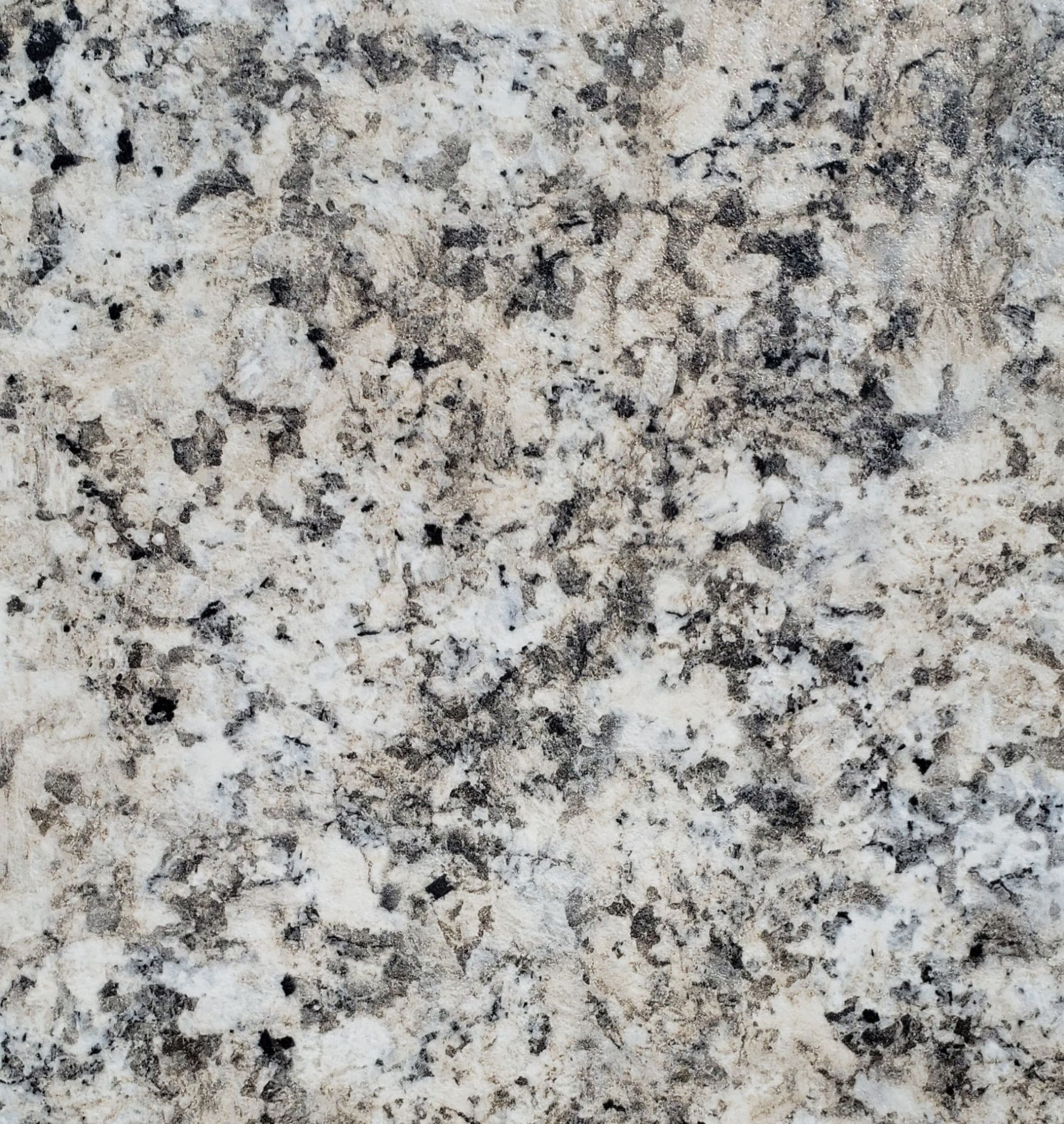 A close up of a white granite counter top