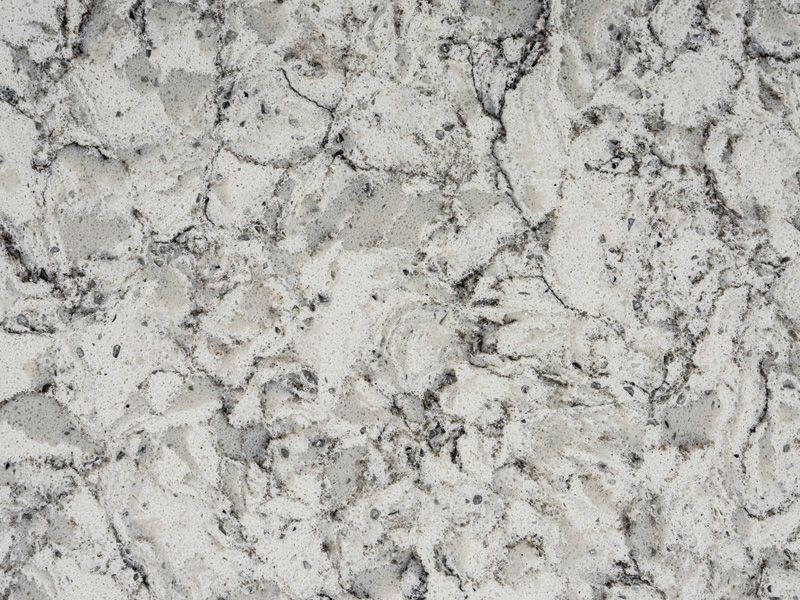 A close up of a white granite counter top.