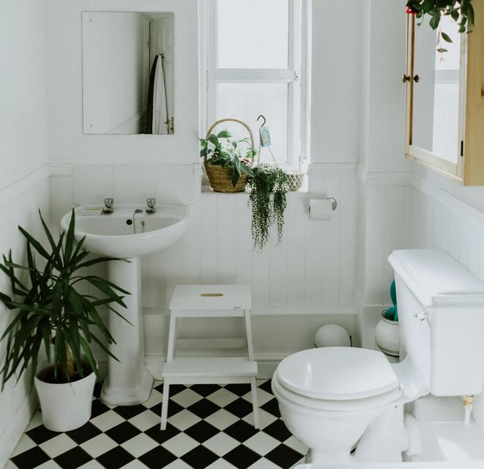 A bathroom with a black and white checkered floor