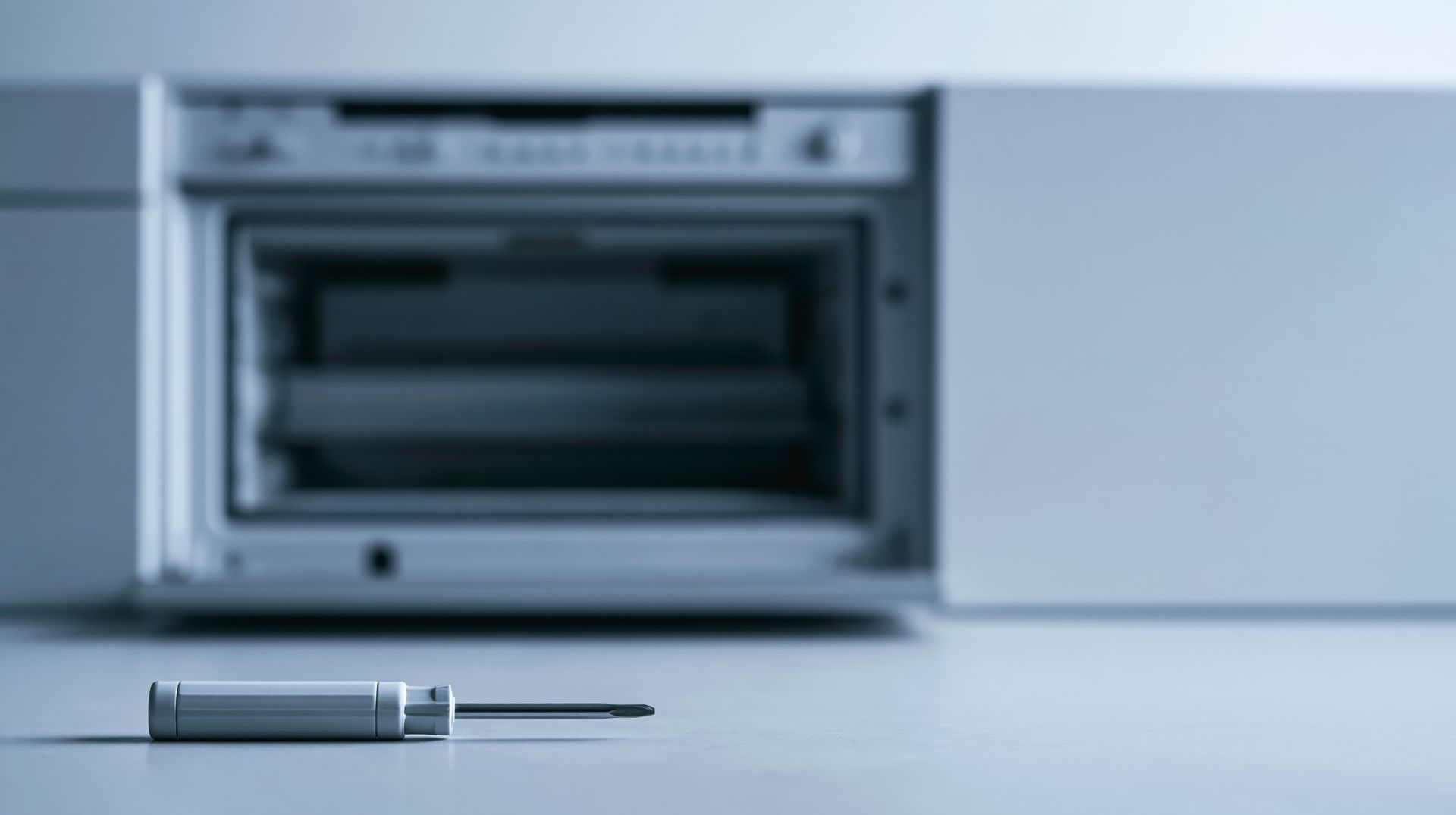 Screwdriver on surface with appliance background