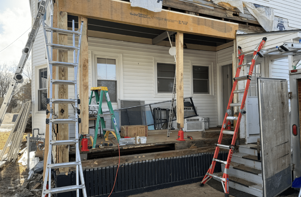A porch is being built on the side of a house.