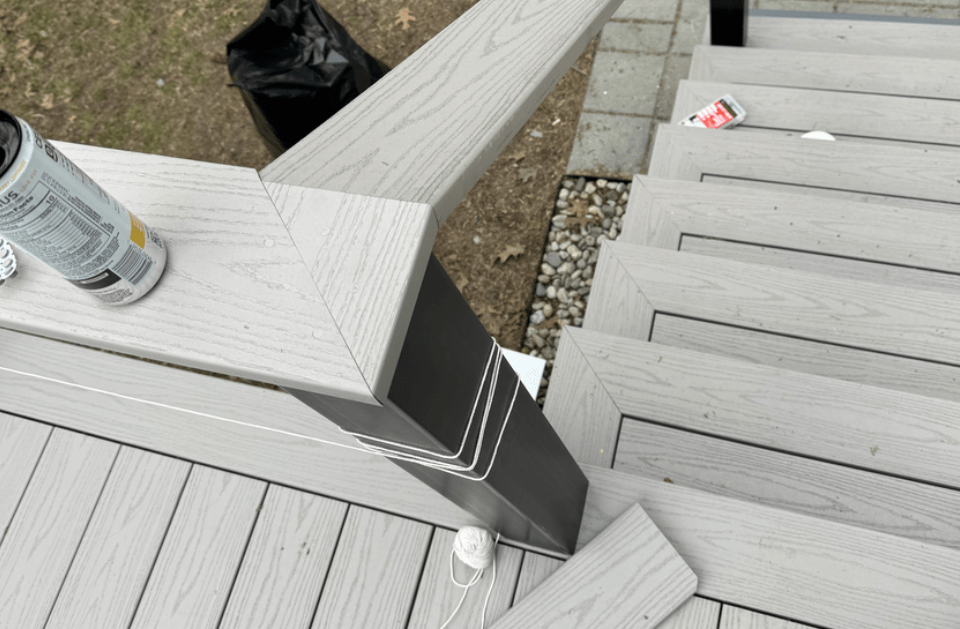 A can of rust oleum paint sits on a wooden deck