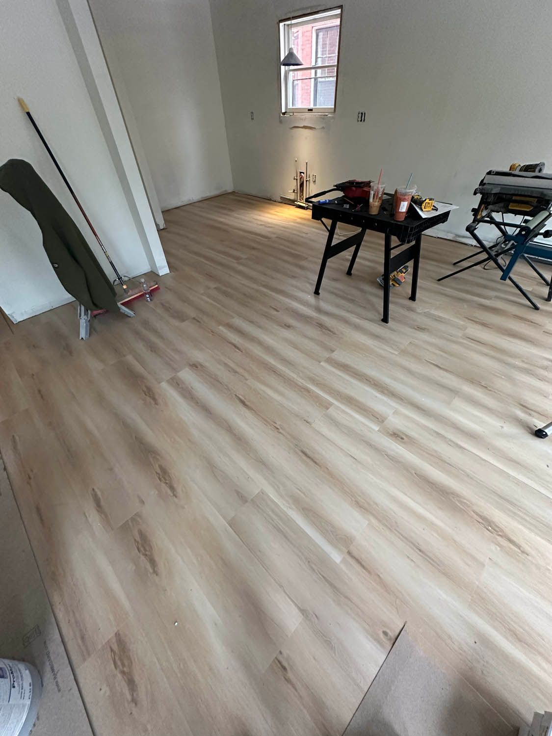 A room with a wooden floor and a table in it.