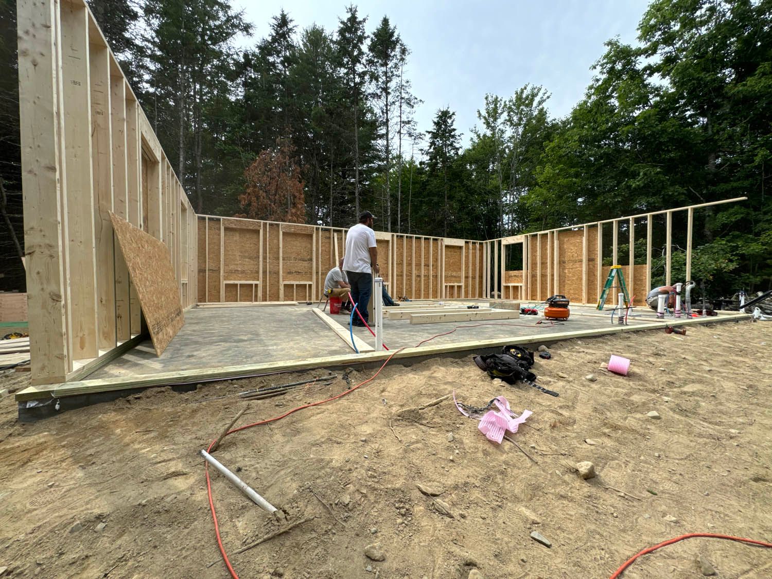 A man is standing in front of a building under construction.
