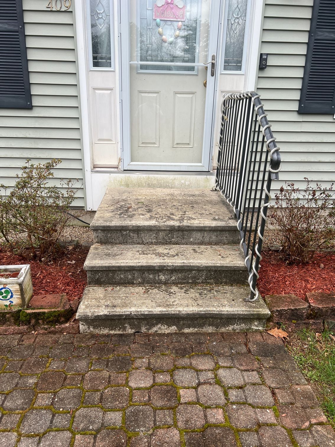 The front steps of a house are very dirty and need to be cleaned.