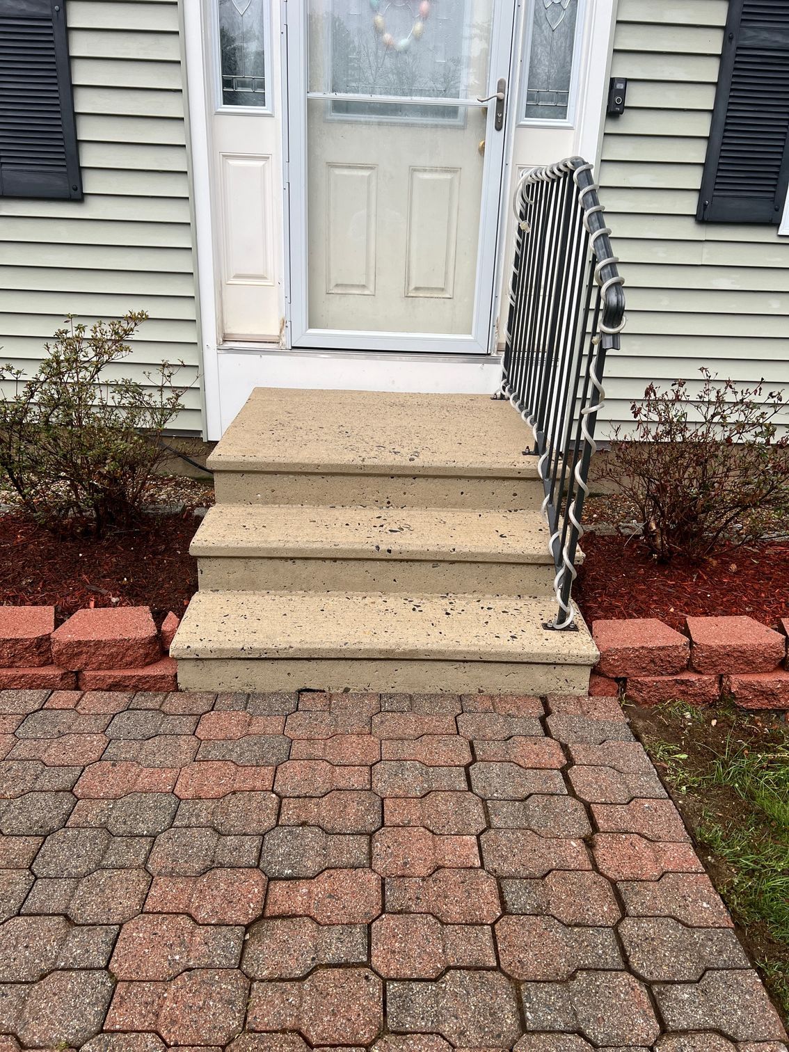 A set of stairs leading up to the front door of a house.