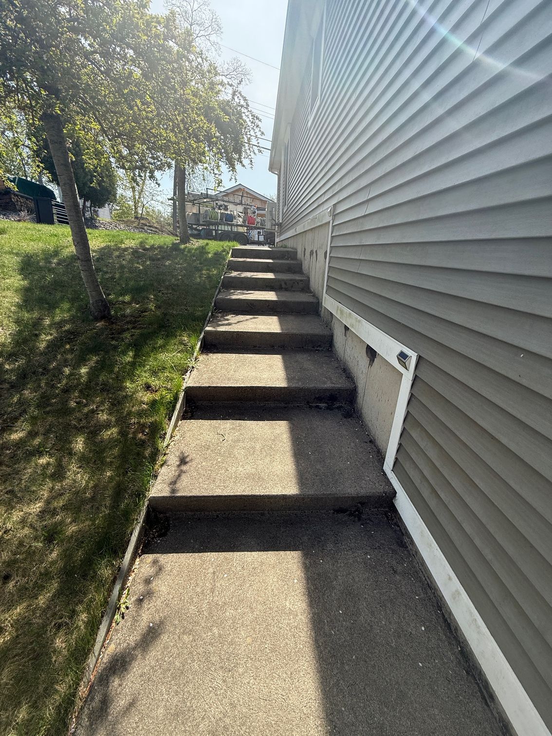 There are stairs leading up to the side of a house.