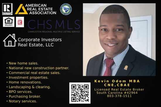 A woman is sitting at a desk with a laptop and a vase of flowers.