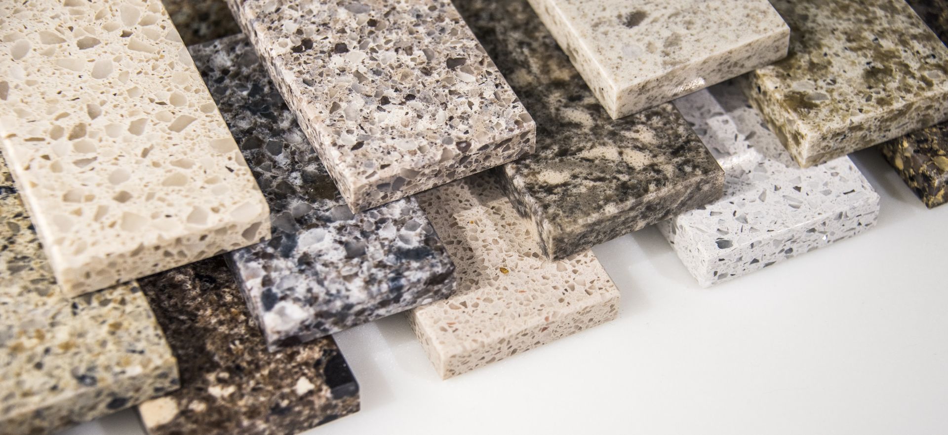 Various samples of granite countertops in different colors and patterns.