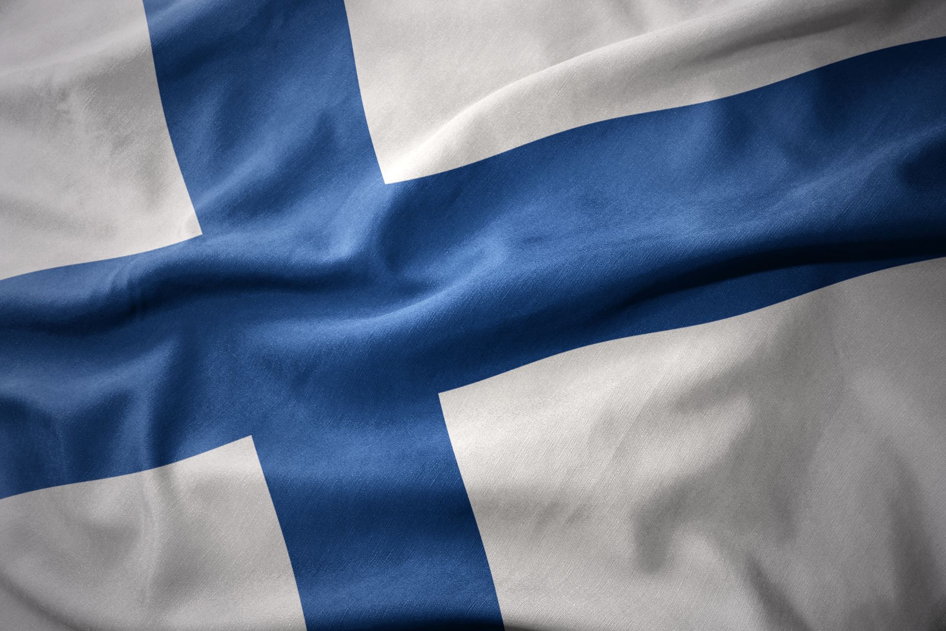 A close up of a finland flag waving in the wind