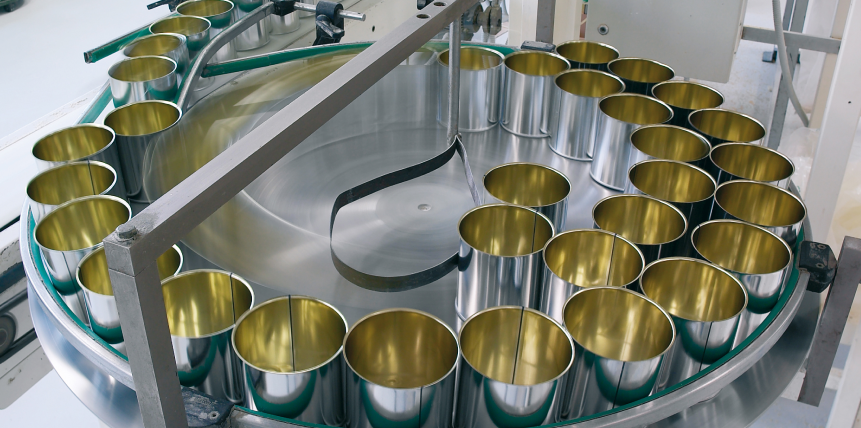 A conveyor belt filled with lots of cans of food