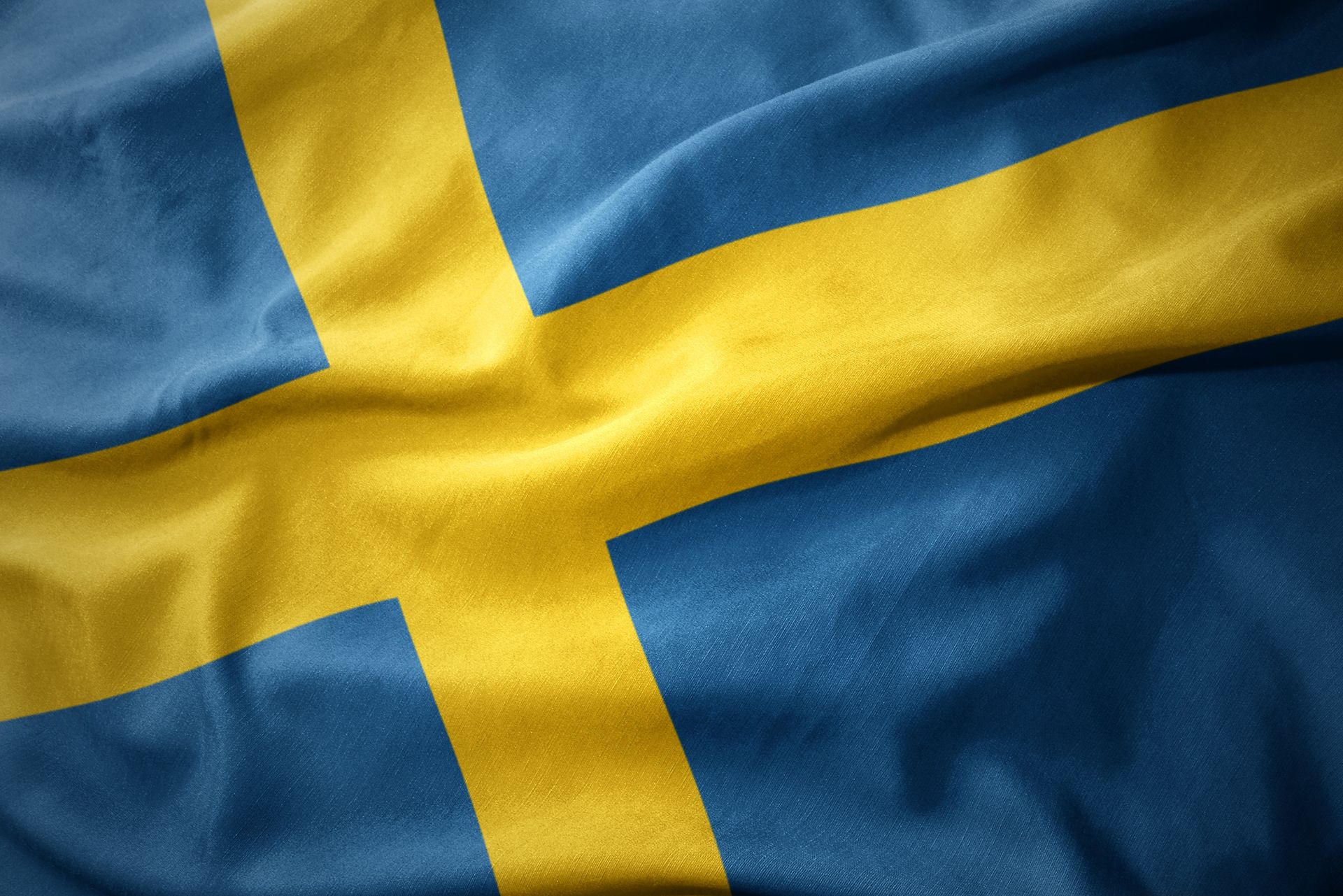 A close up of a swedish flag waving in the wind