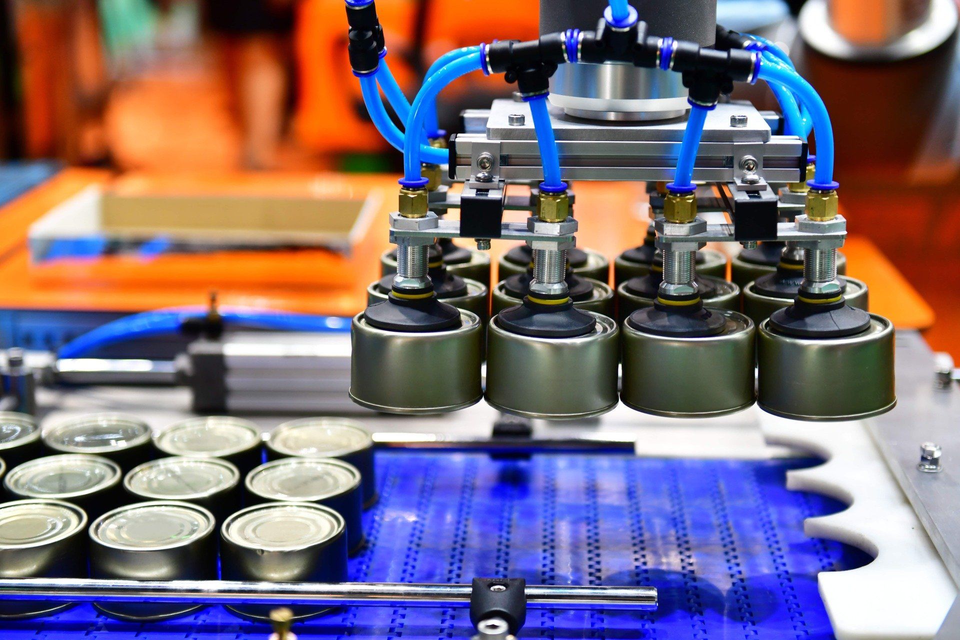 A machine is moving cans on a conveyor belt.