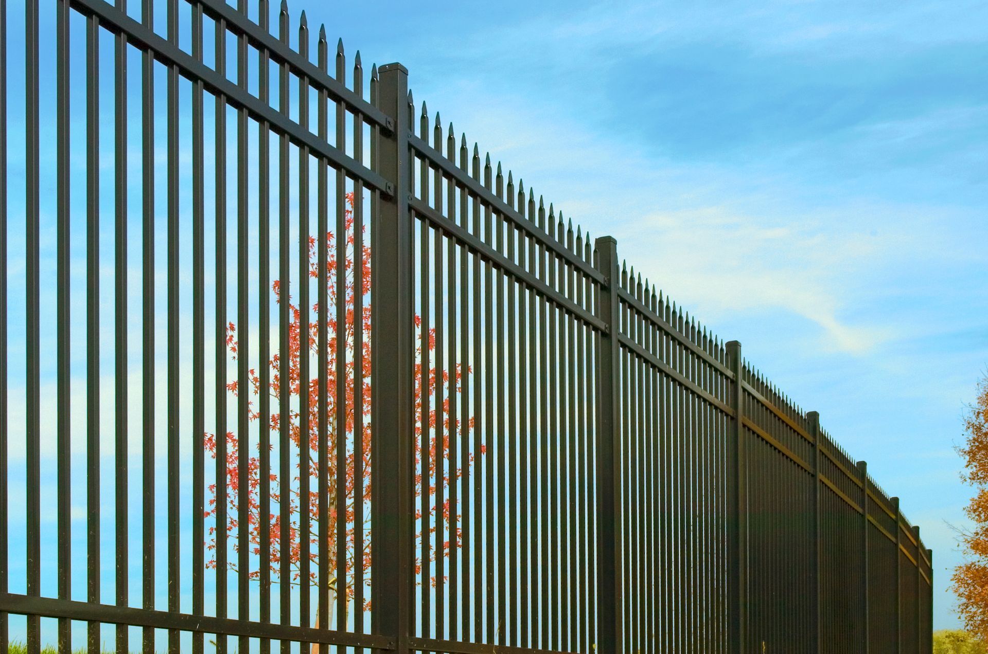Close-up of an installed steel fence, showcasing fencing services.
