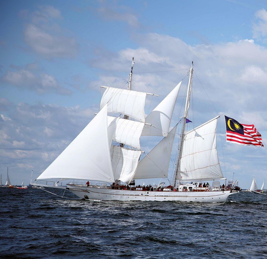A sailboat with a flag on the side of it