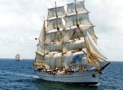 A large sailboat is floating on top of a large body of water.