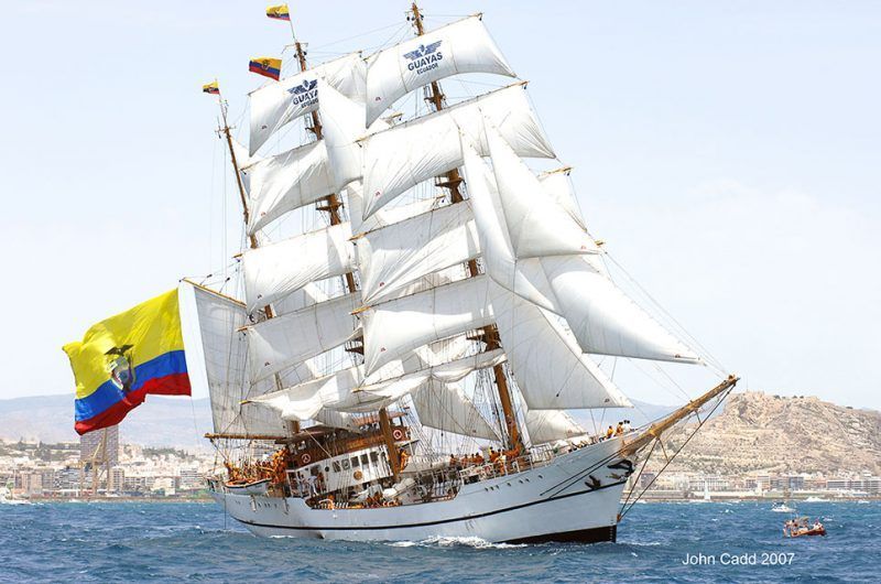 A large sailboat is floating on top of a body of water.