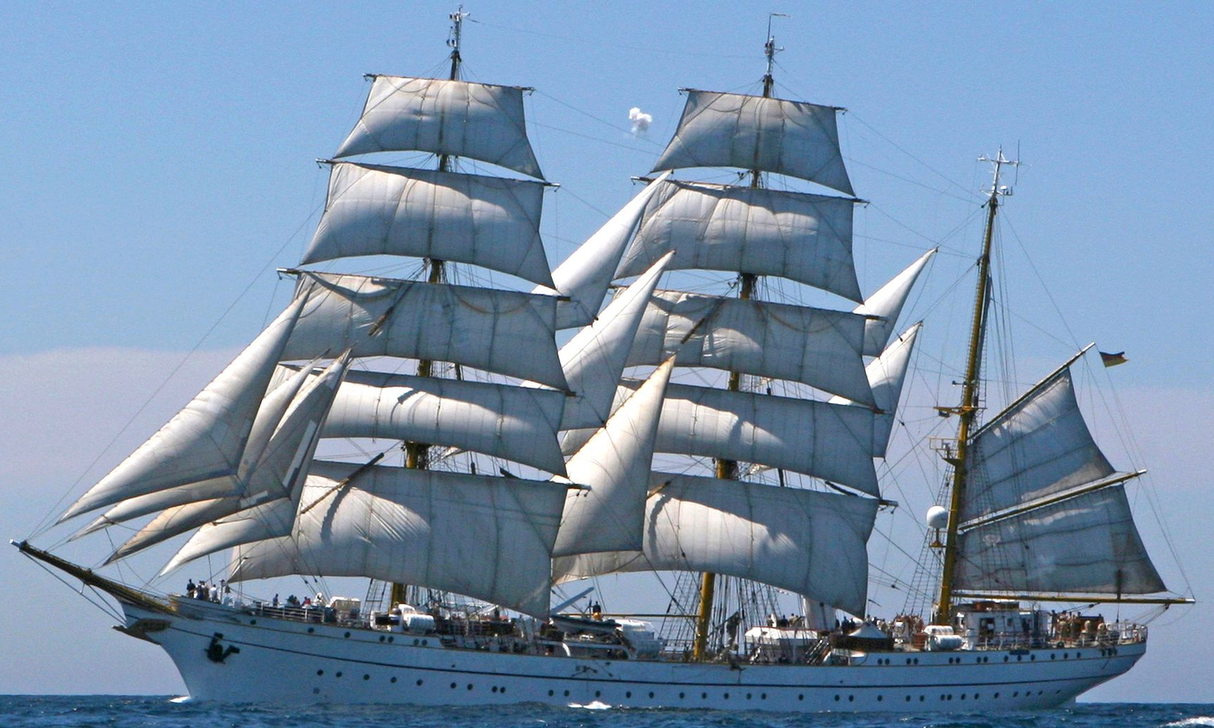 A large sailboat is floating on top of a large body of water.