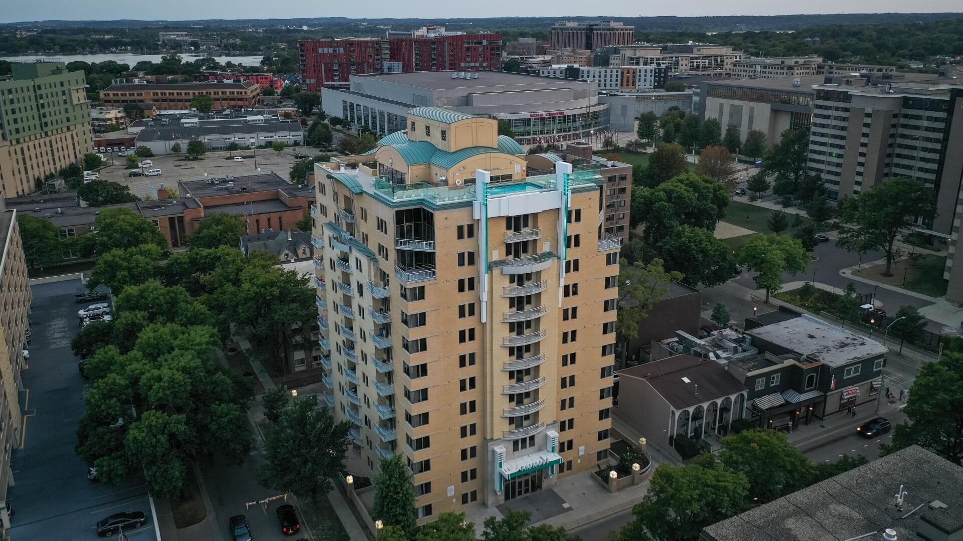 An aerial view of a city with a tall building in the middle