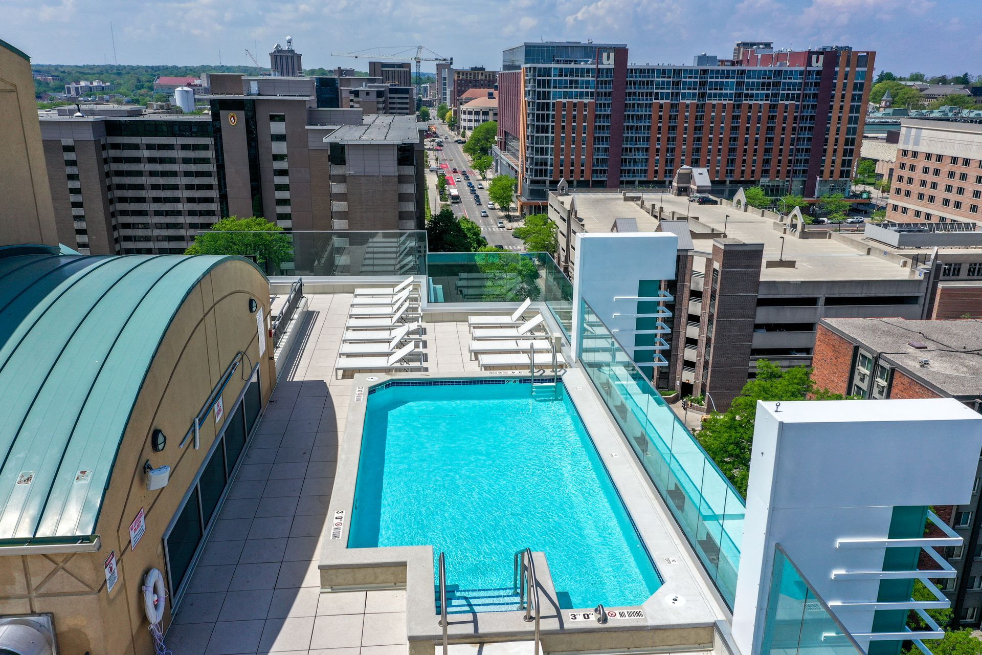 An aerial view of a large swimming pool on top of a building