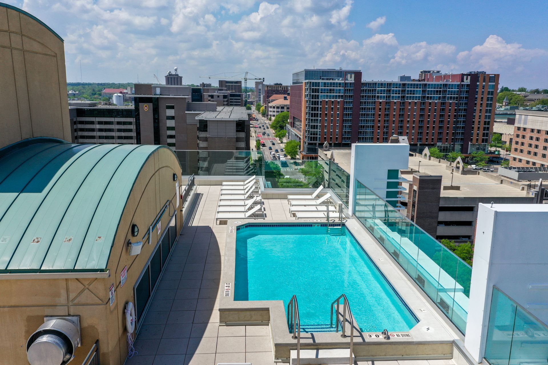 An aerial view of a large swimming pool on the roof of a building