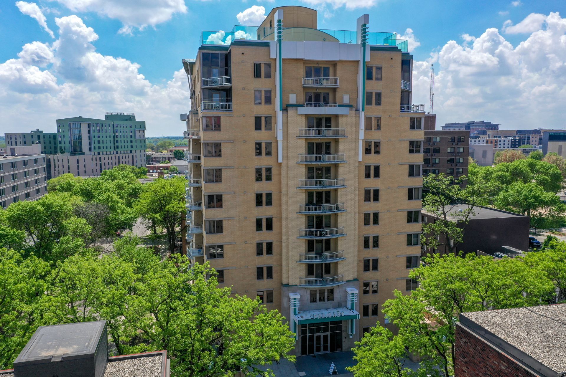 An aerial view of a tall building surrounded by trees