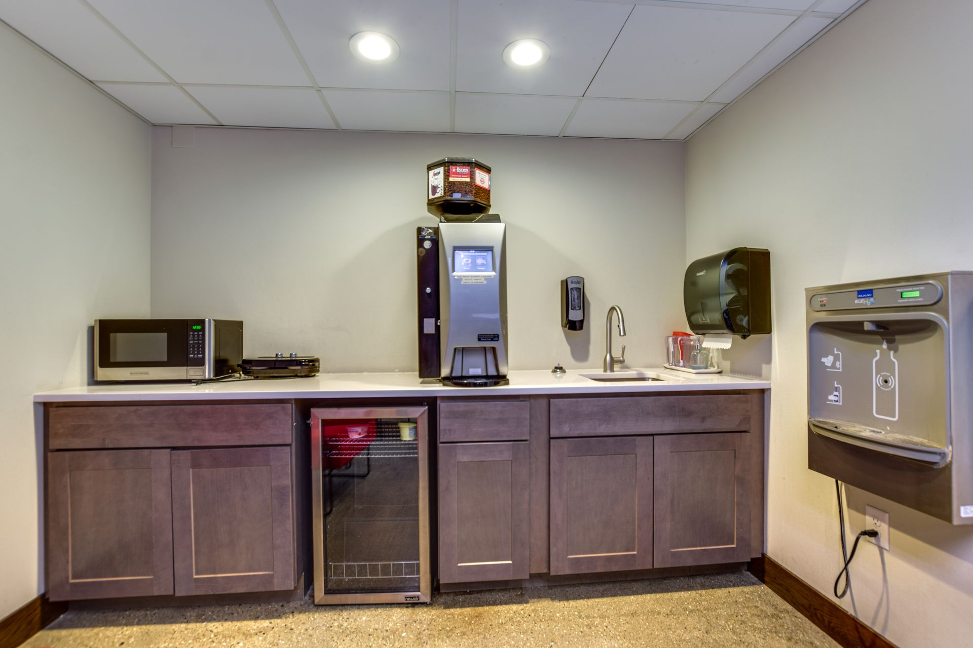 A kitchen with a microwave and a refrigerator