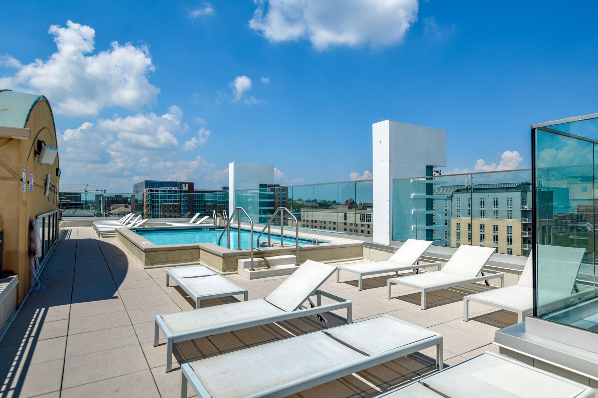 There is a swimming pool on the roof of a building.