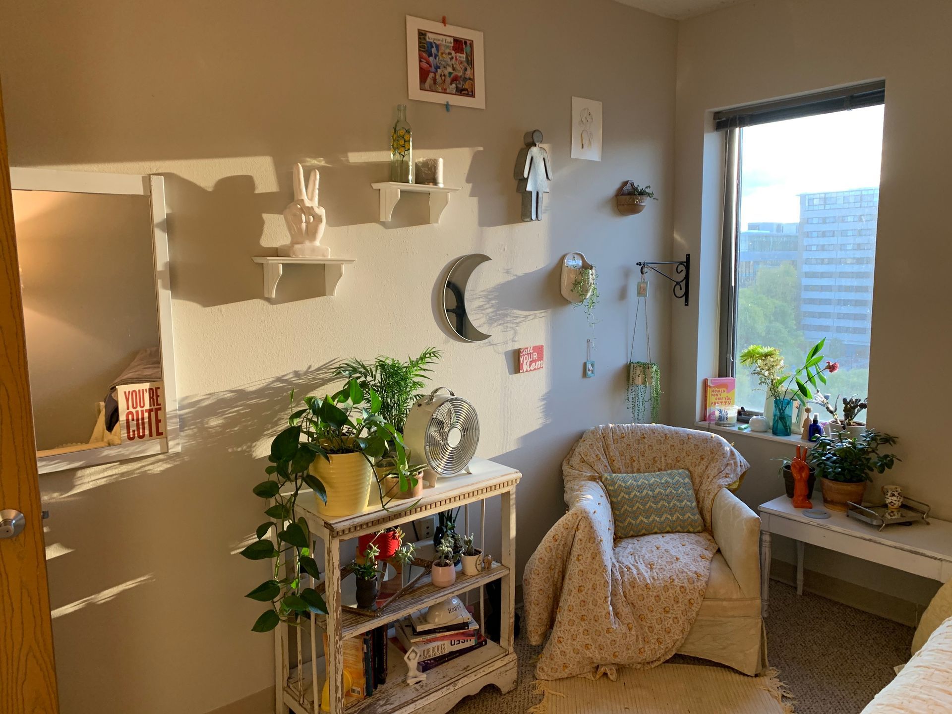 A room with a chair , shelf , and window.