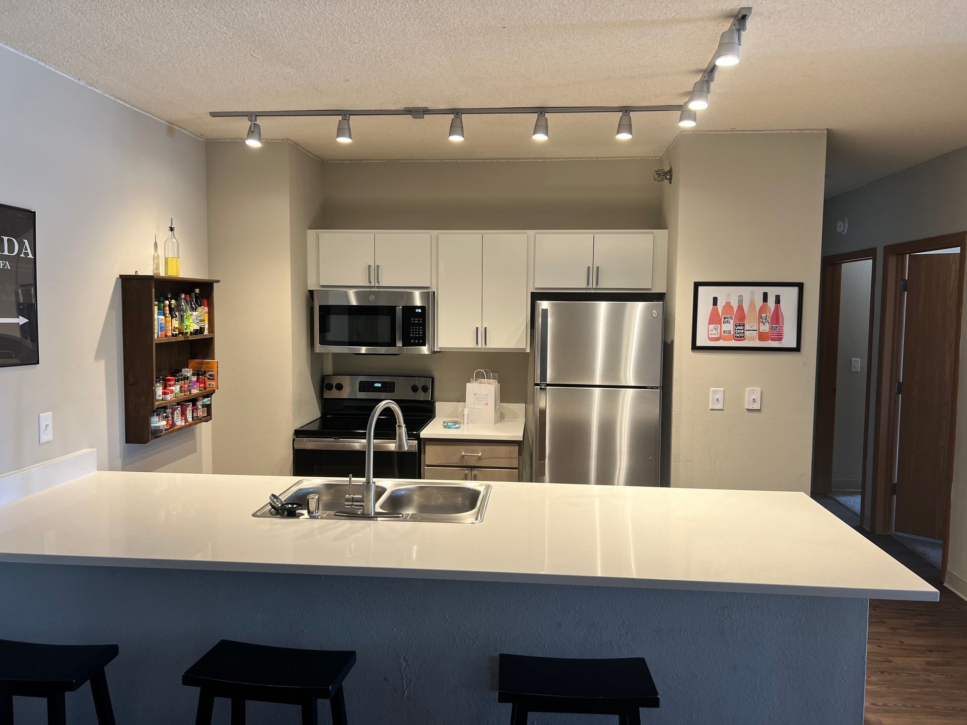 A kitchen with stainless steel appliances and white cabinets