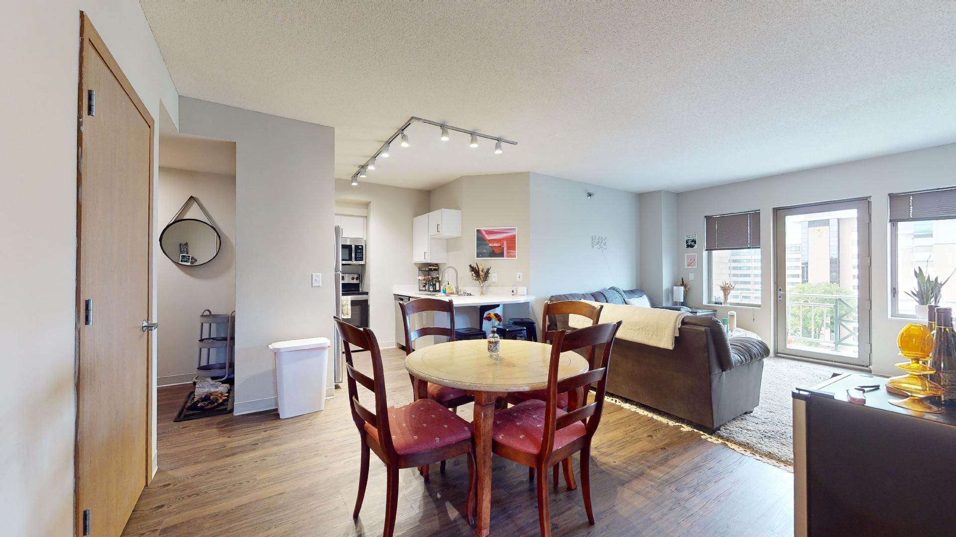 A living room with a dining table and chairs and a couch.