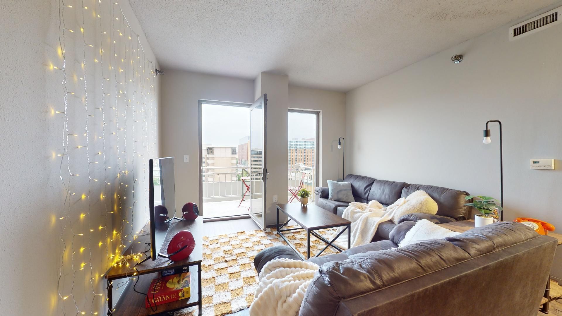 A living room with a couch , table , and television.