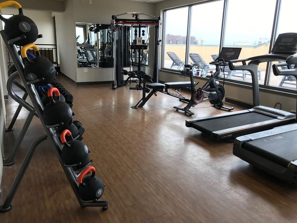 A gym with a treadmill and a bike