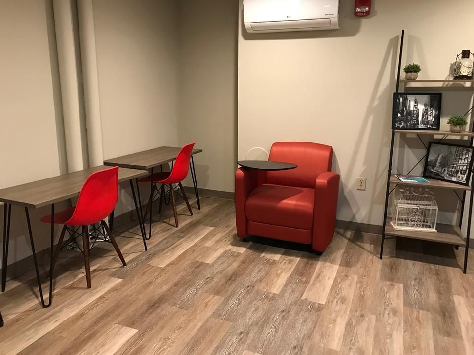 There is a red chair in the middle of the room.