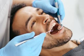 male patient at dentist getting checkup