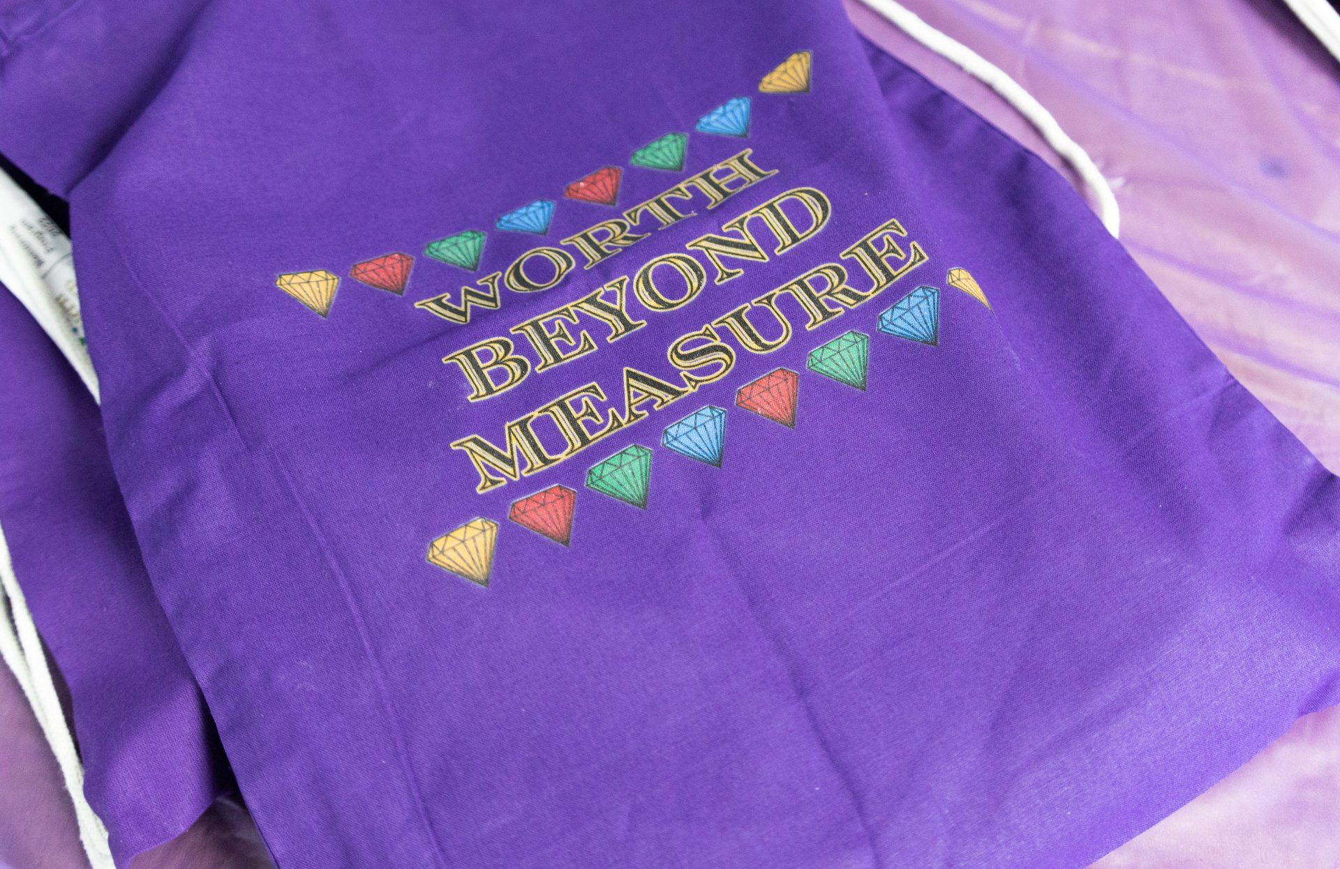 a purple shirt that says worth beyond measure