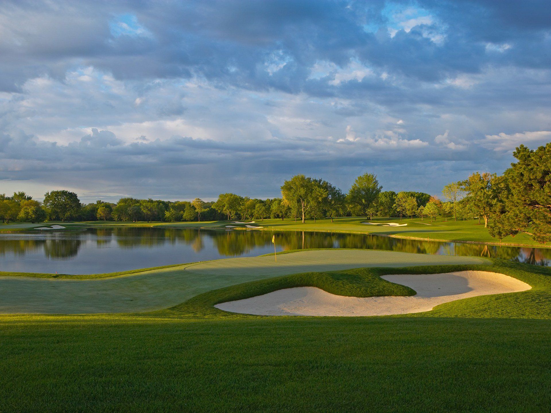 A golf course with a lake in the background.