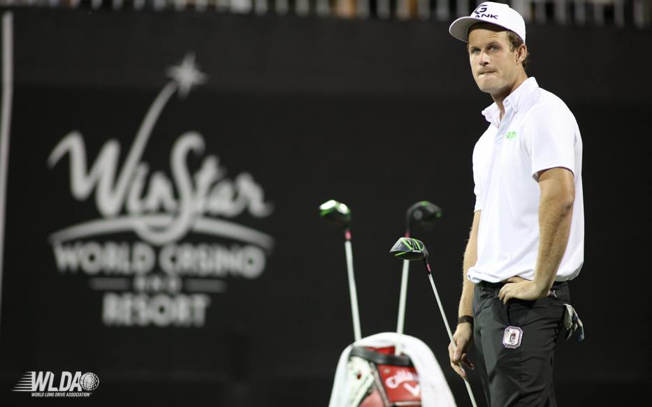 A man is standing in front of a sign that says world casino resort