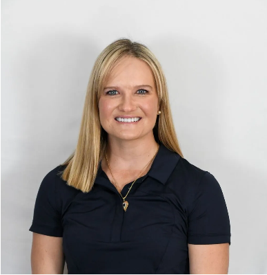 A woman wearing a yellow hat is sitting on a bench