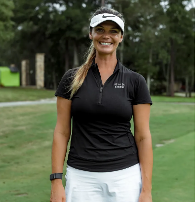 A woman wearing a yellow hat is sitting on a bench