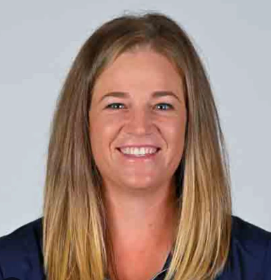 A woman wearing a yellow hat is sitting on a bench
