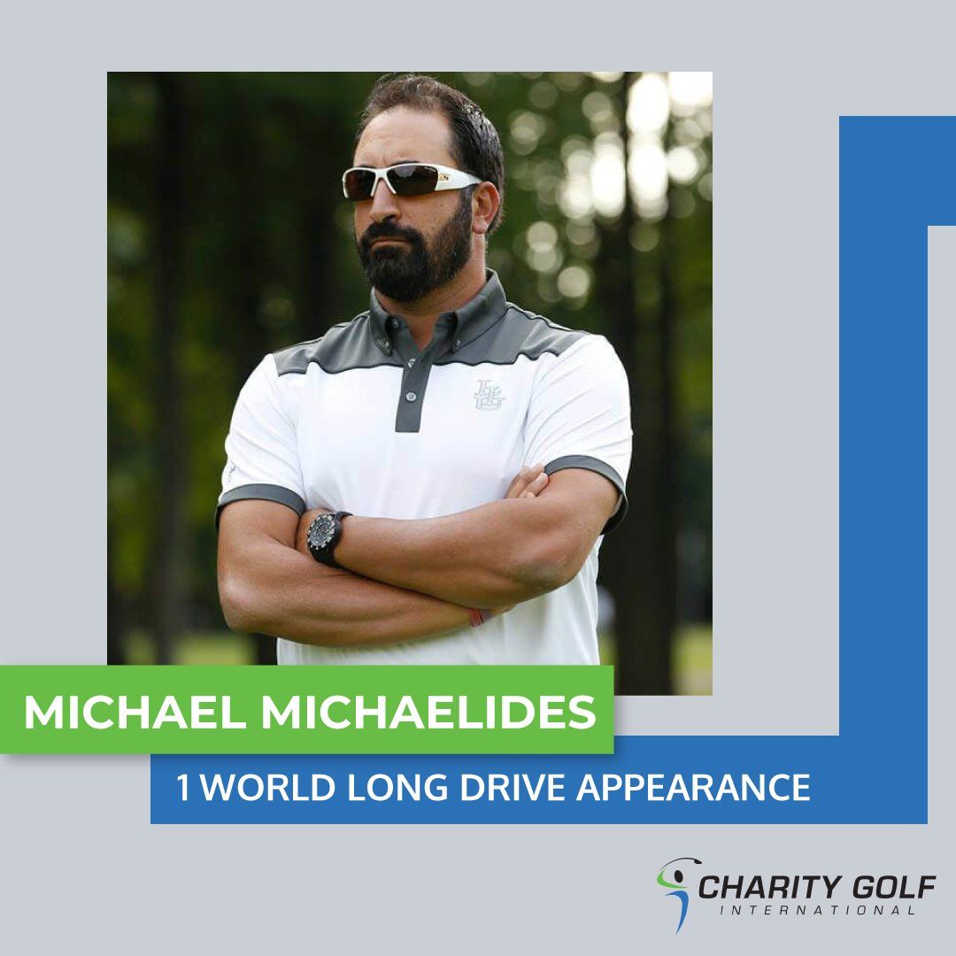 A man wearing sunglasses and a white shirt stands with his arms crossed