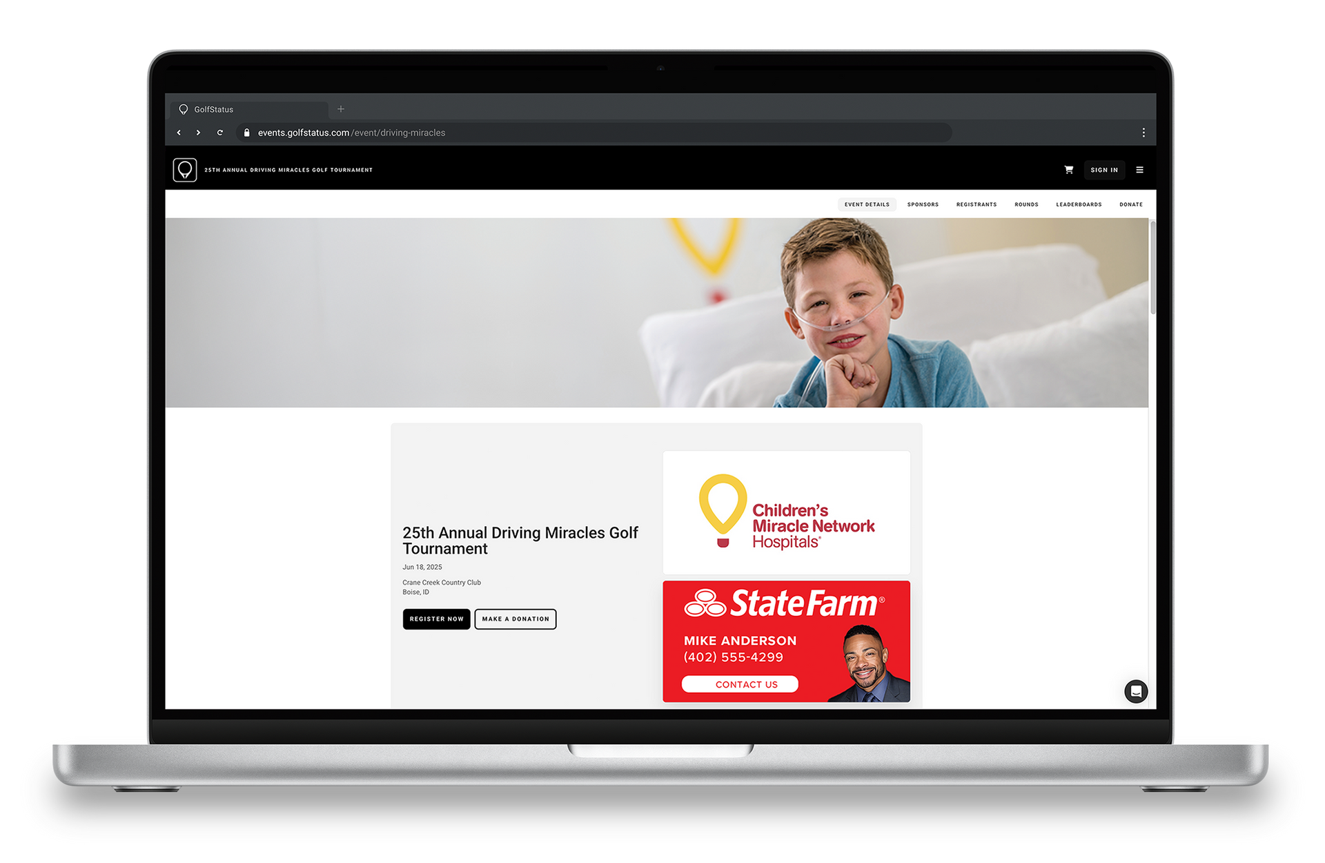 The home page of a golf tournament website is displayed on a laptop computer.
