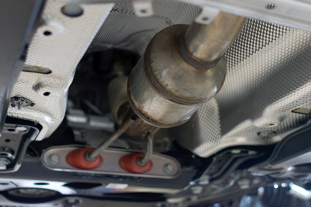 A close up of a exhaust pipe on the underside of a car — Antons Recycling In Ciccone, NT