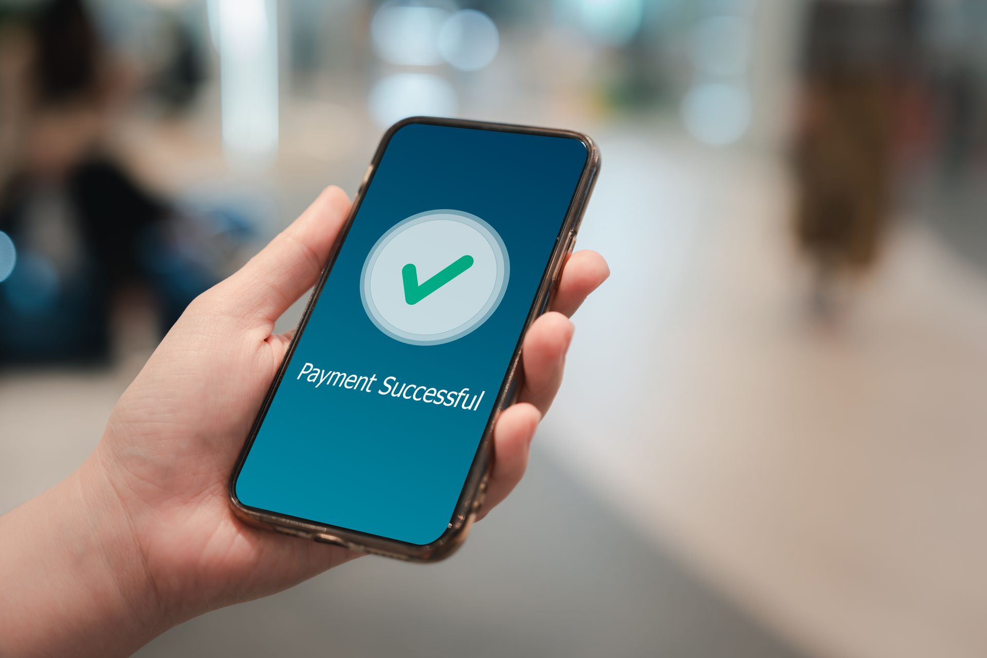 Hand holding a phone displaying a 